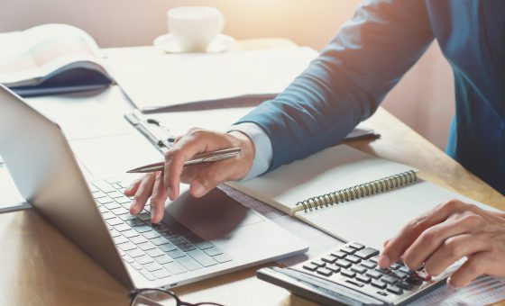 businessman working in office with using calculator and laptop. concept finance and accounting